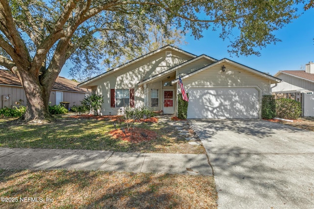 ranch-style home with a garage and a front lawn