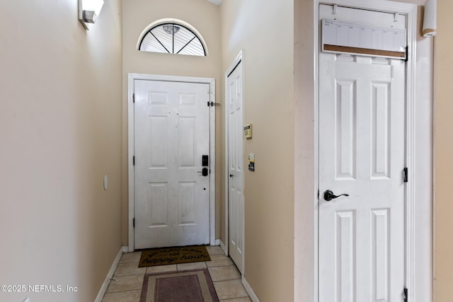 doorway to outside with light tile patterned flooring