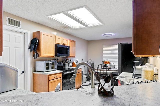 kitchen with range with two ovens and a textured ceiling