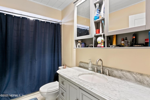 bathroom with ornamental molding, vanity, toilet, and curtained shower