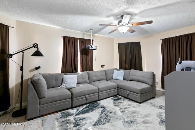 living room with light tile patterned flooring, a textured ceiling, and ceiling fan