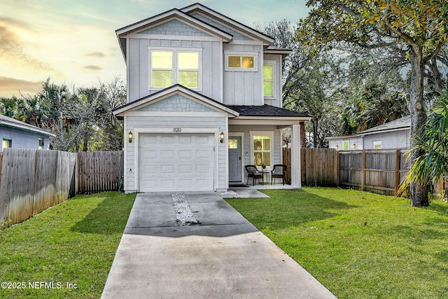 craftsman-style house featuring a garage and a lawn