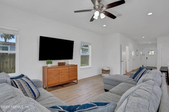 living room featuring ceiling fan and light hardwood / wood-style floors