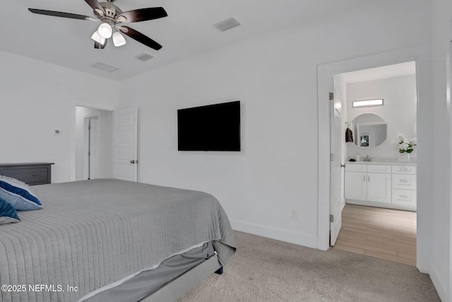 carpeted bedroom featuring sink and ceiling fan