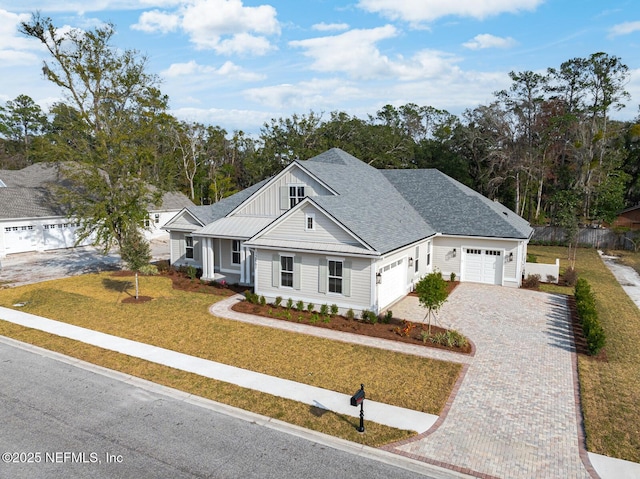 view of front of property featuring a garage and a front lawn