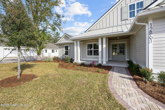 doorway to property featuring a lawn