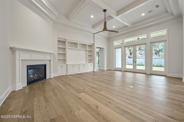 unfurnished living room with coffered ceiling, crown molding, light hardwood / wood-style floors, and ceiling fan