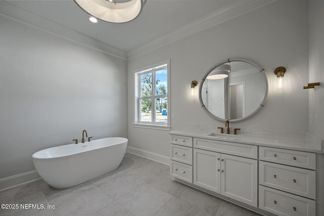 bathroom with crown molding, a washtub, and vanity