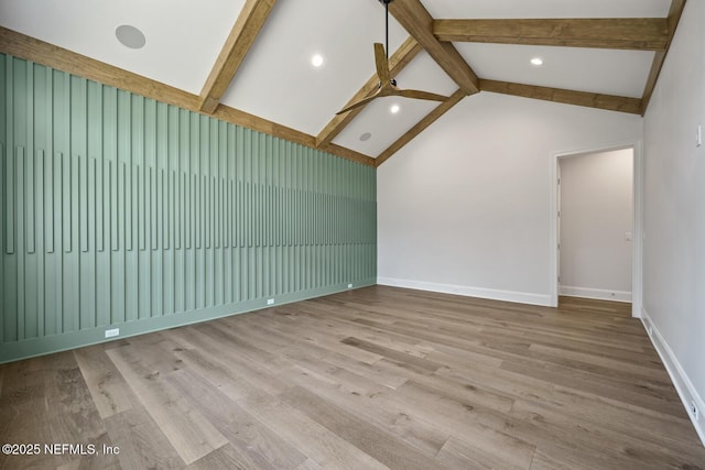 unfurnished living room with vaulted ceiling with beams and light wood-type flooring