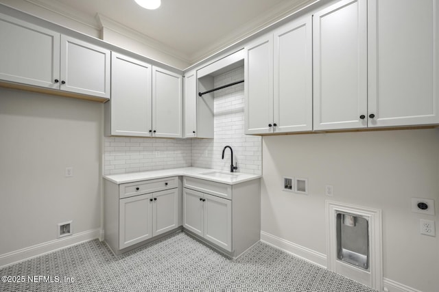 washroom featuring electric dryer hookup, sink, washer hookup, and cabinets