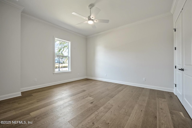 empty room with crown molding, ceiling fan, and hardwood / wood-style floors