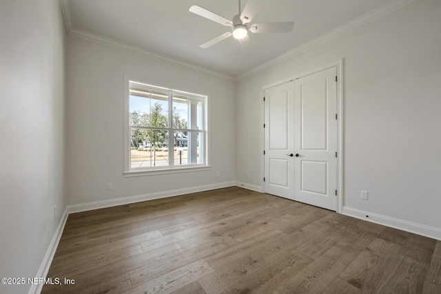 unfurnished bedroom with ceiling fan, a closet, ornamental molding, and light hardwood / wood-style flooring