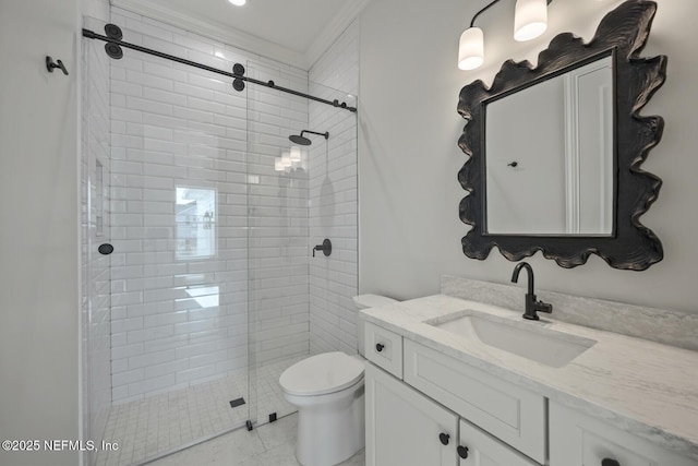 bathroom with vanity, tiled shower, and toilet