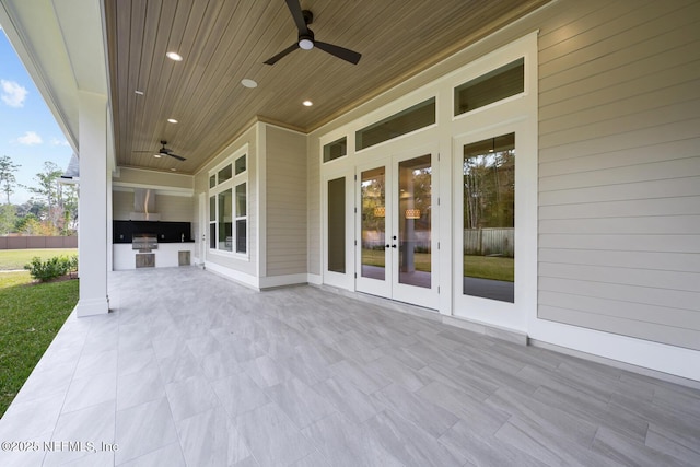 view of patio featuring french doors, ceiling fan, an outdoor kitchen, and area for grilling