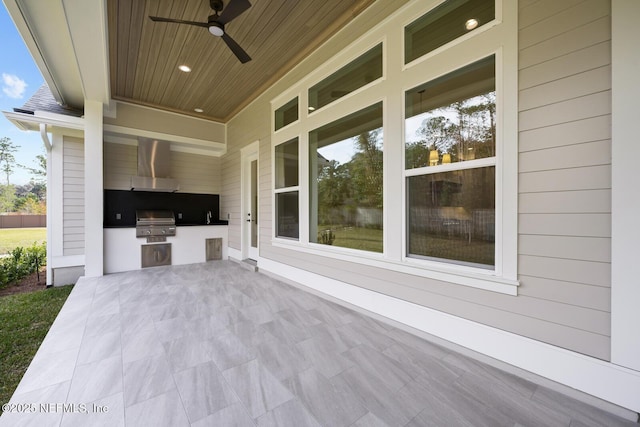 view of patio / terrace featuring a grill, sink, ceiling fan, and exterior kitchen