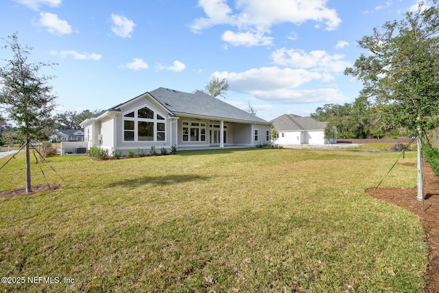 back of house with a lawn