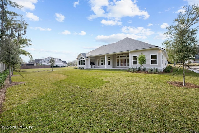 back of house with a lawn