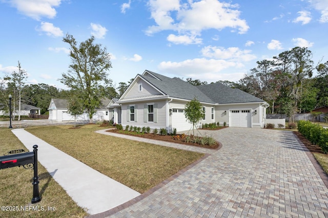 view of front of home featuring a garage and a front yard