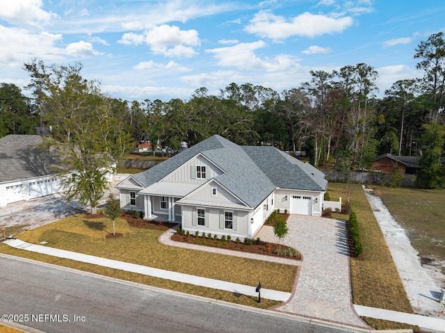 view of front of home with a garage and a front lawn