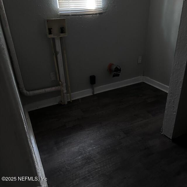 clothes washing area featuring dark hardwood / wood-style floors