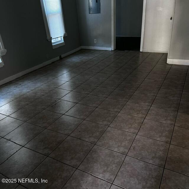 spare room featuring dark tile patterned flooring