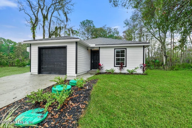 ranch-style home featuring a garage and a front yard