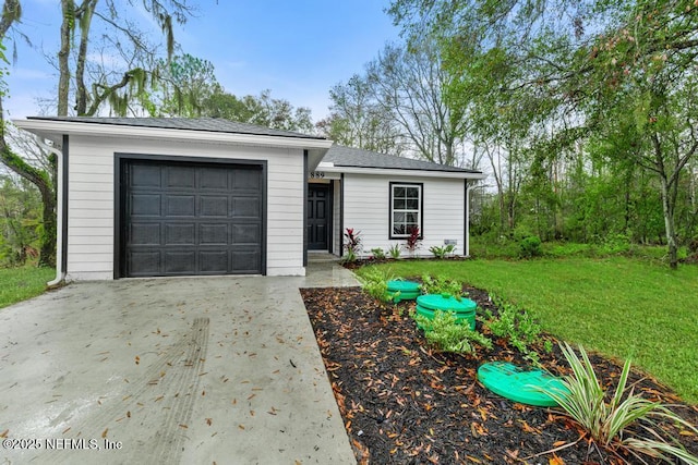 ranch-style home with a garage and a front lawn