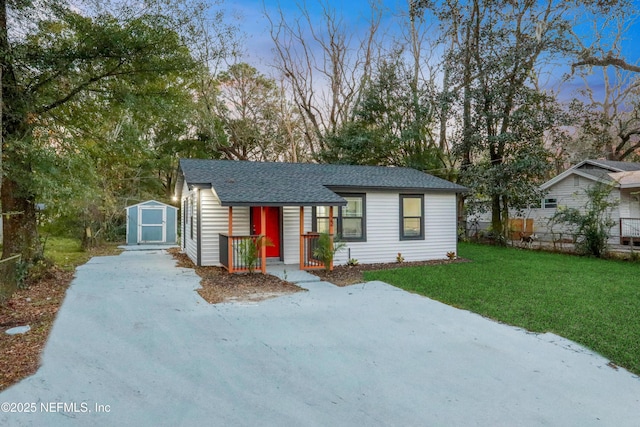 view of front of home featuring a storage shed and a yard