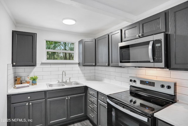 kitchen featuring tasteful backsplash, ornamental molding, stainless steel appliances, and sink