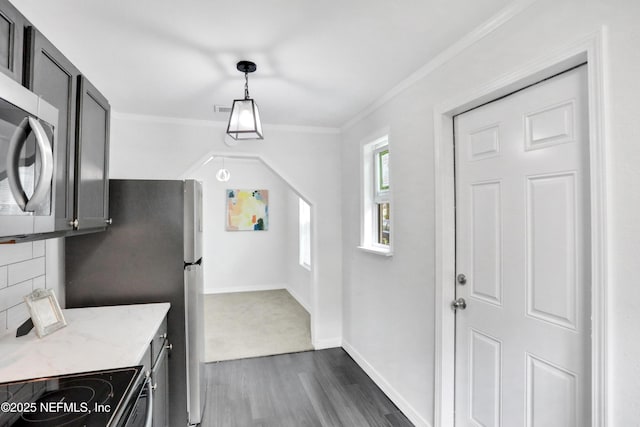 kitchen featuring crown molding, electric range, dark hardwood / wood-style floors, light stone countertops, and decorative light fixtures