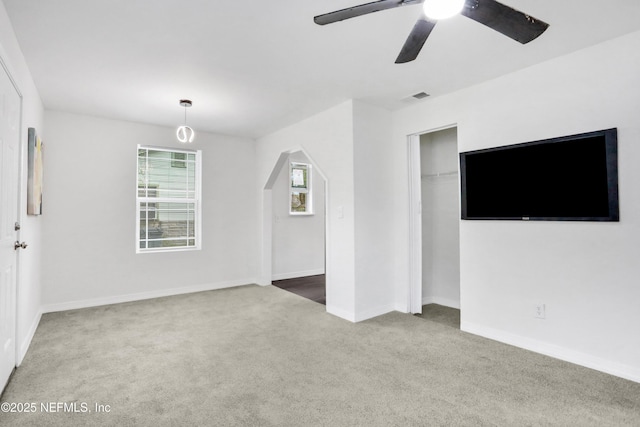 unfurnished living room featuring carpet floors and ceiling fan