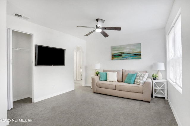 living room with plenty of natural light and ceiling fan