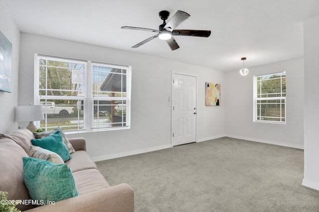 living room featuring ceiling fan and light colored carpet