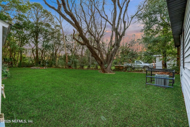 view of yard at dusk