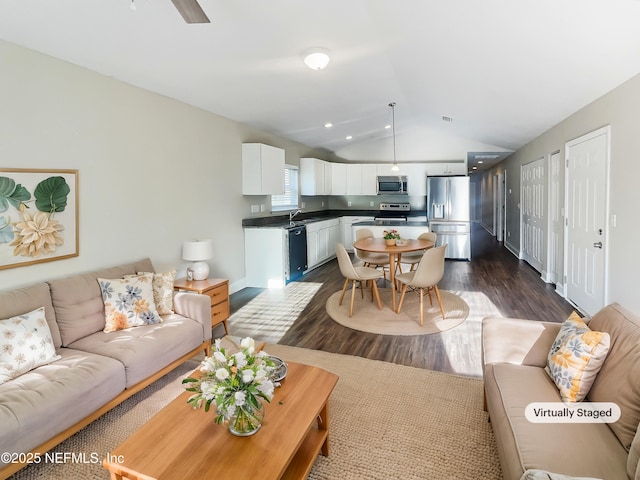 living room with vaulted ceiling and dark hardwood / wood-style flooring