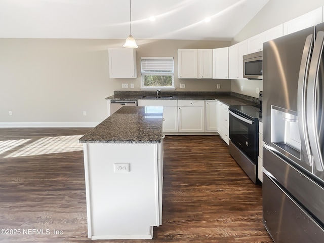 kitchen with white cabinetry, sink, decorative light fixtures, and stainless steel appliances