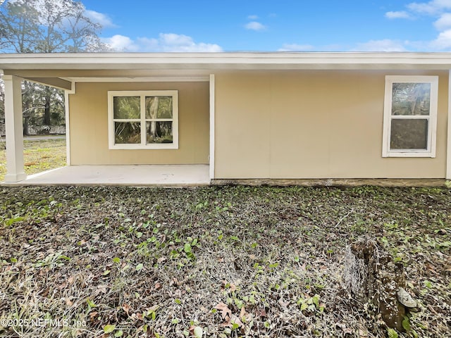 view of property exterior with a patio area