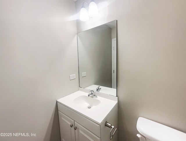 bathroom featuring vanity and toilet