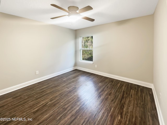 spare room with ceiling fan and dark hardwood / wood-style flooring