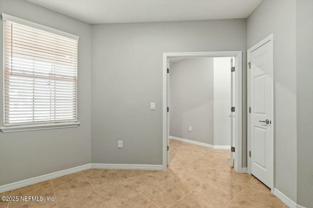 unfurnished room featuring light tile patterned floors