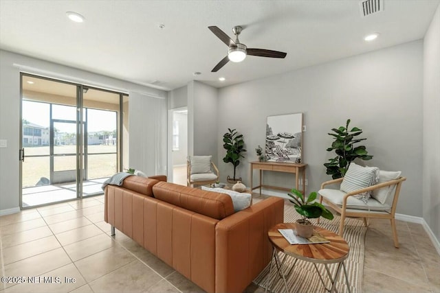 tiled living room featuring ceiling fan