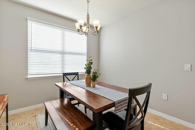 tiled dining space featuring a notable chandelier