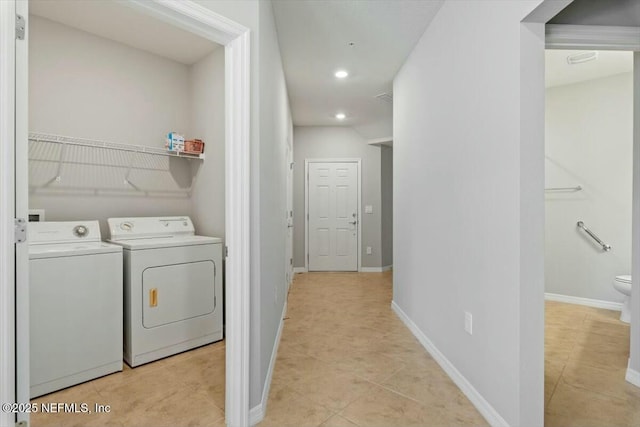 laundry room with light tile patterned floors and washer and clothes dryer