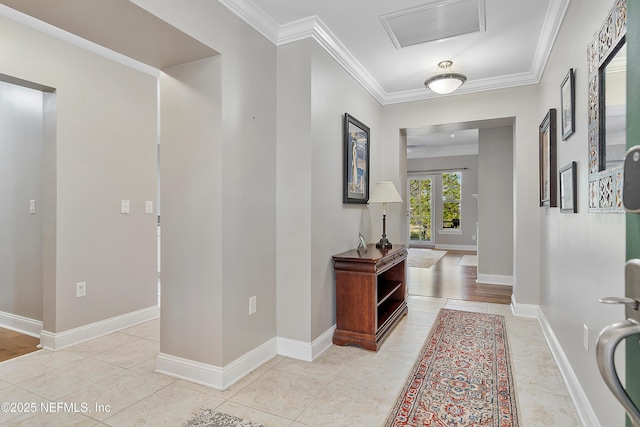 hallway with light tile patterned flooring and ornamental molding