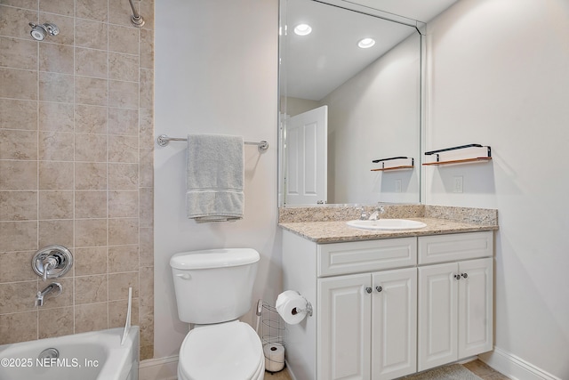 full bathroom with vanity, tiled shower / bath combo, and toilet