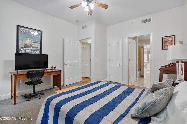 carpeted bedroom with ceiling fan and ensuite bathroom