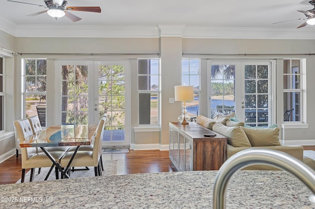 sunroom featuring french doors and ceiling fan