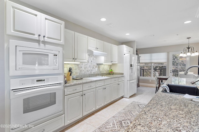 kitchen featuring sink, white cabinets, and white appliances