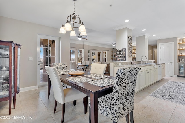 tiled dining room with wine cooler, sink, ornamental molding, and ceiling fan