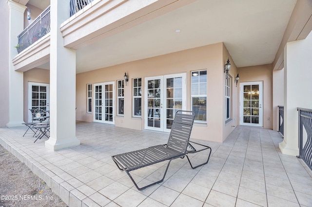 view of patio / terrace with french doors and a balcony